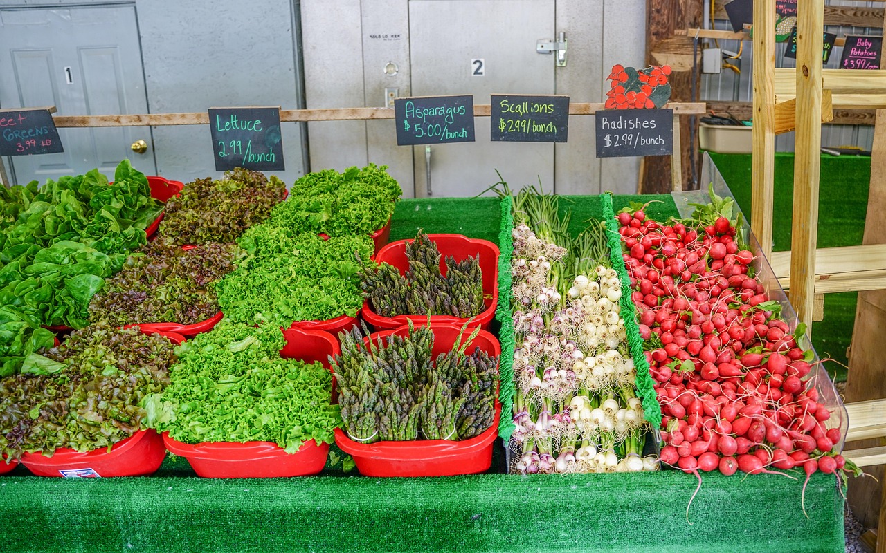 Vegetables and produce in red bins at a market.